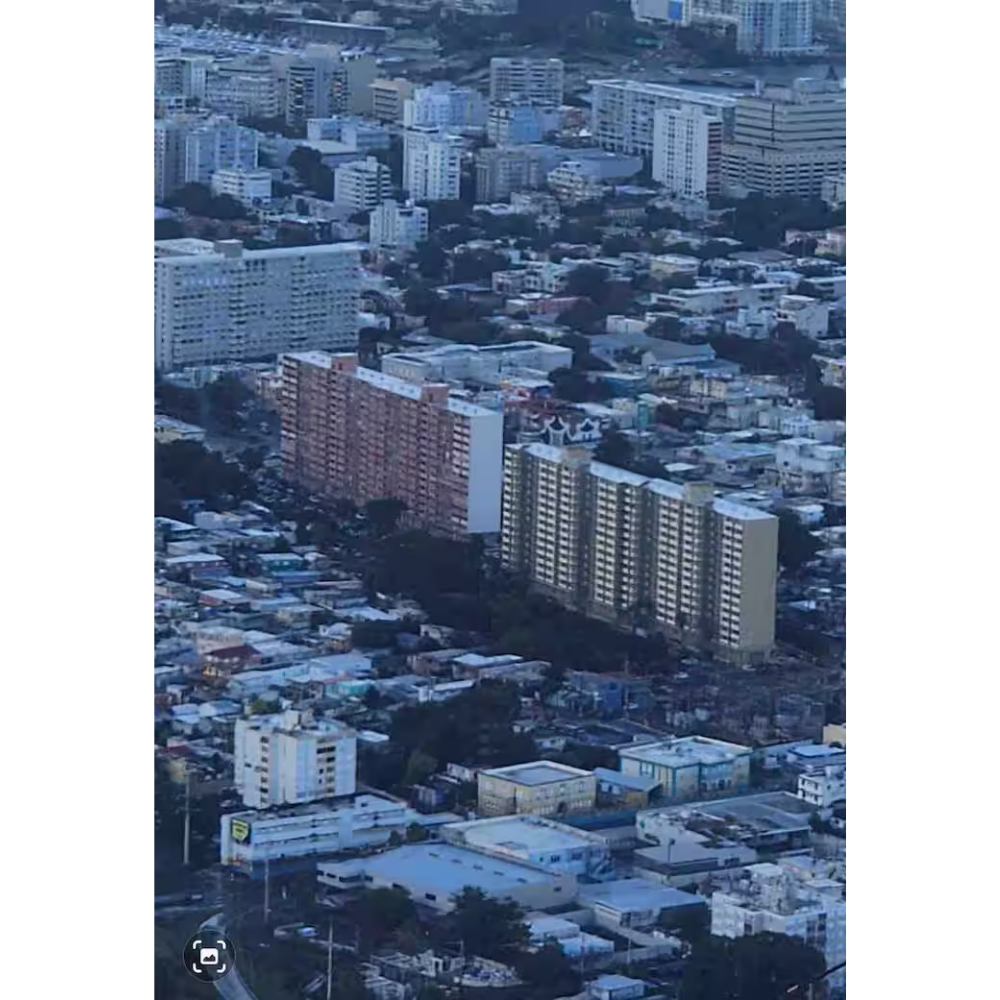 A cityscape with numerous high-rise apartment buildings in an urban area, featuring a mix of residential and commercial structures.
