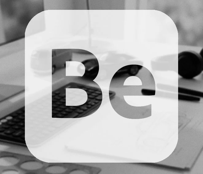 A desk with a remote control, a calculator, a pair of glasses, and some other office supplies.