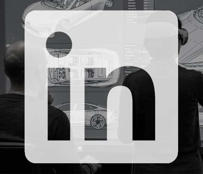 Two people observing design sketches and technical drawings of cars on a display screen.