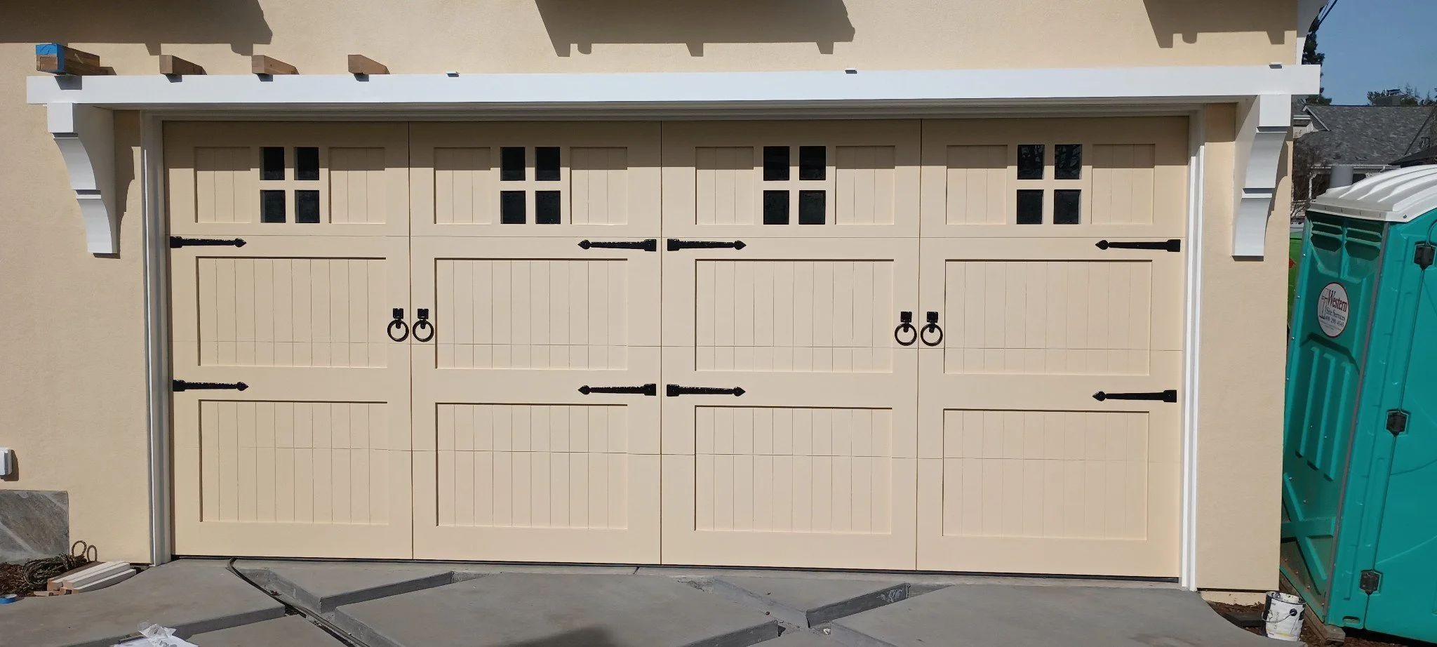 2 car garage door wood grain stone house