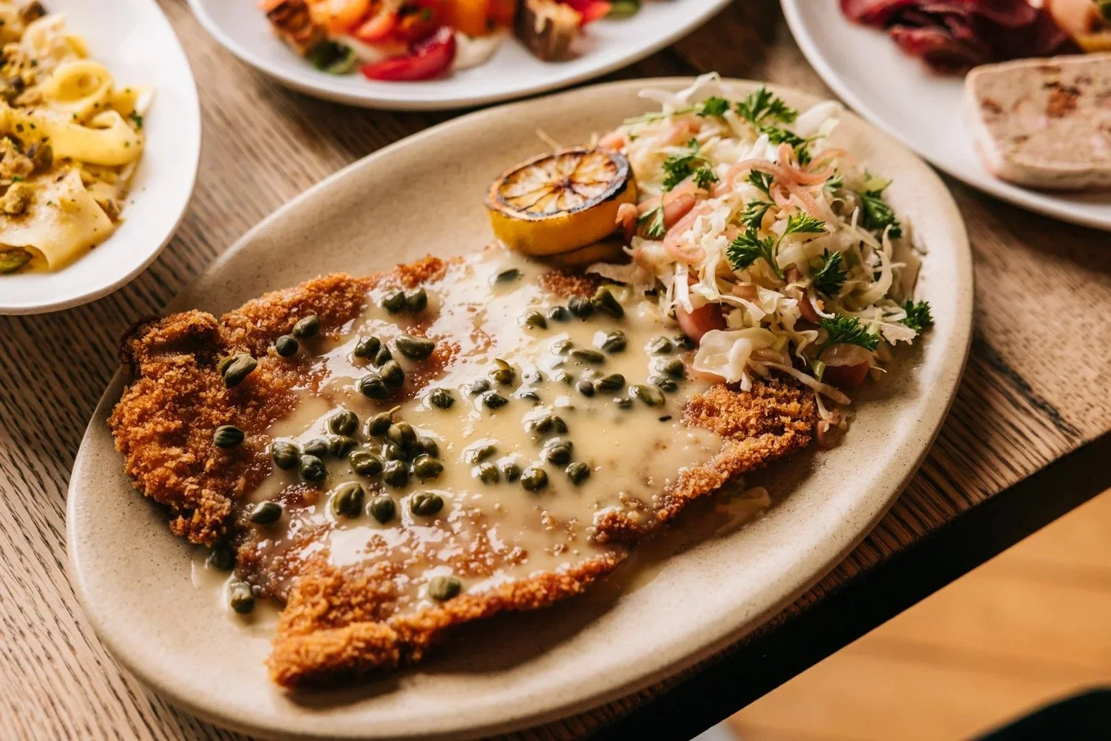 Pork schnitzel with beurre blanc and capers at Table, Donkey and Stick