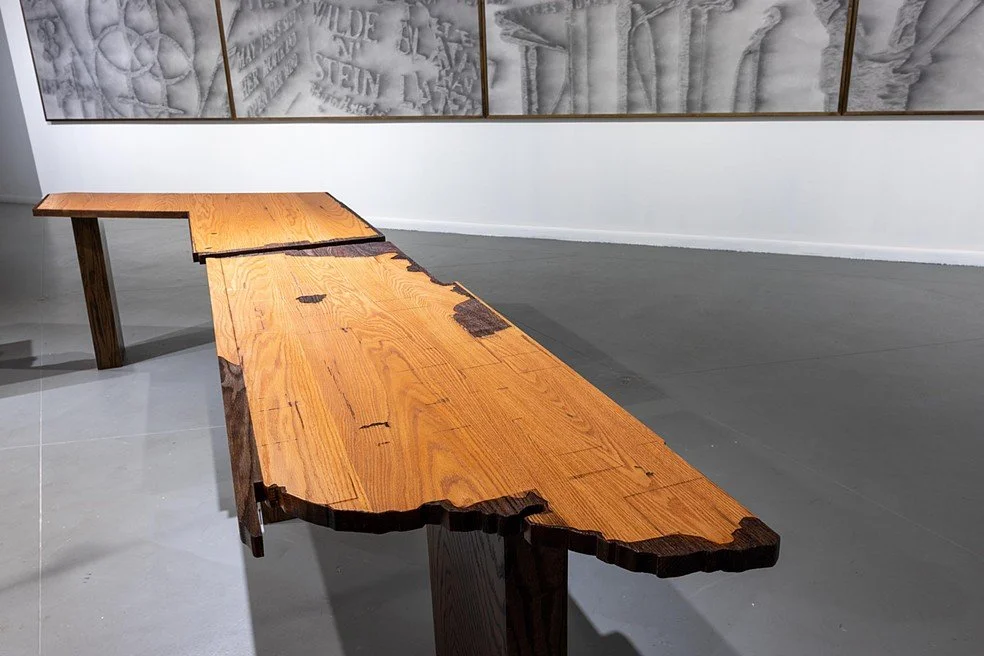 Seven sculptural tables modeled on the ripped out bar tops from Mary's Naturally - a longtime hub of queer culture and organizing - show the outlines of photographs decoupaged to the surface and the scars from being torn out of the building when it w