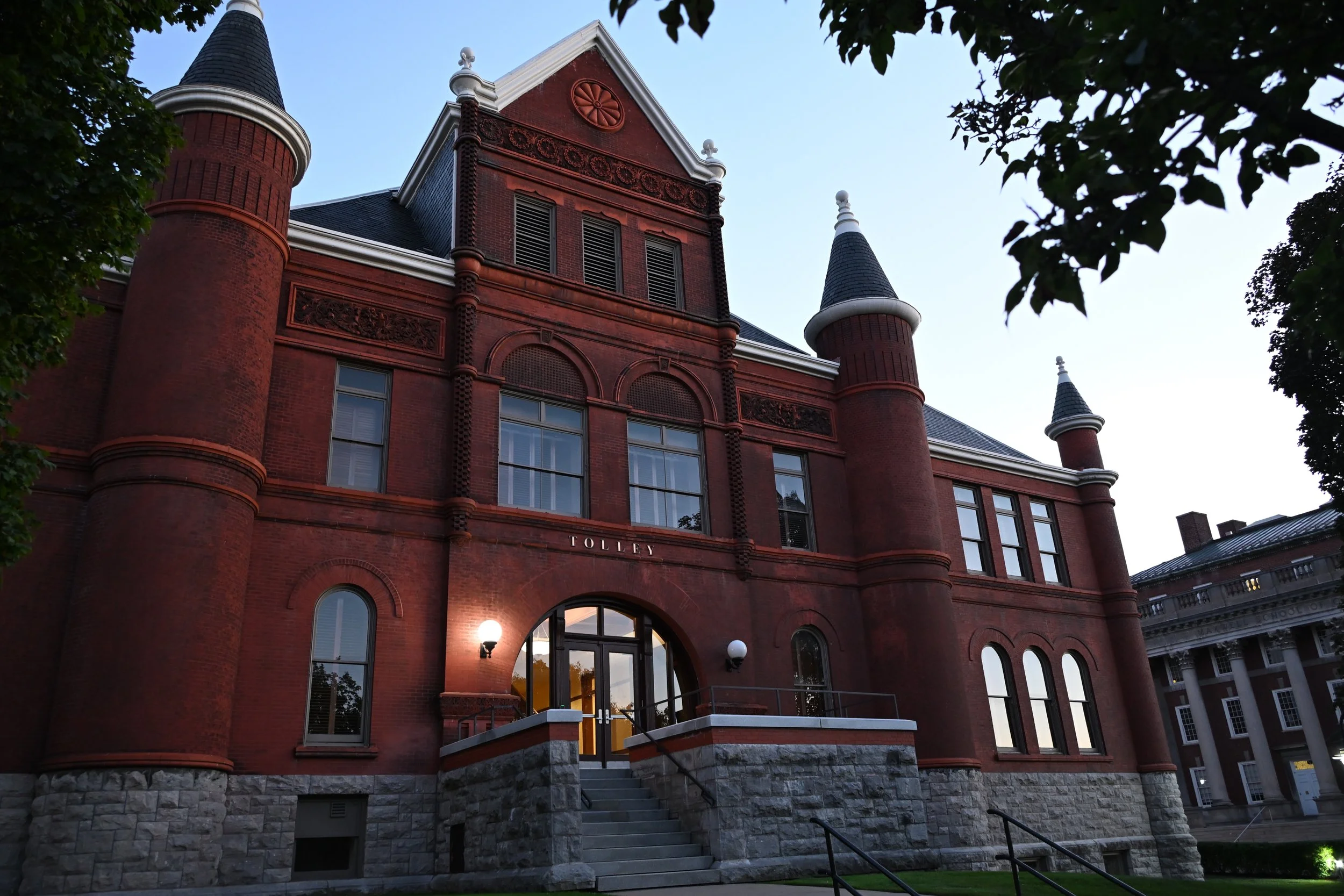 Syracuse University Tolley Humanities Building lit on a fall evening. Photo by Emily Hoban.