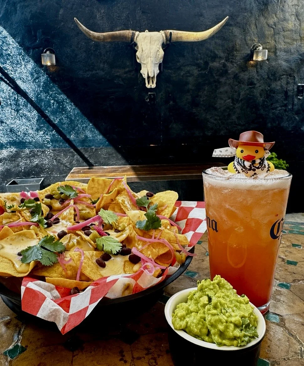 Delicious nachos and guacamole and cocktail