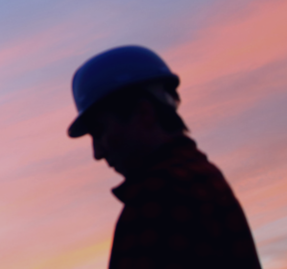 A silhouette of a man in construction
