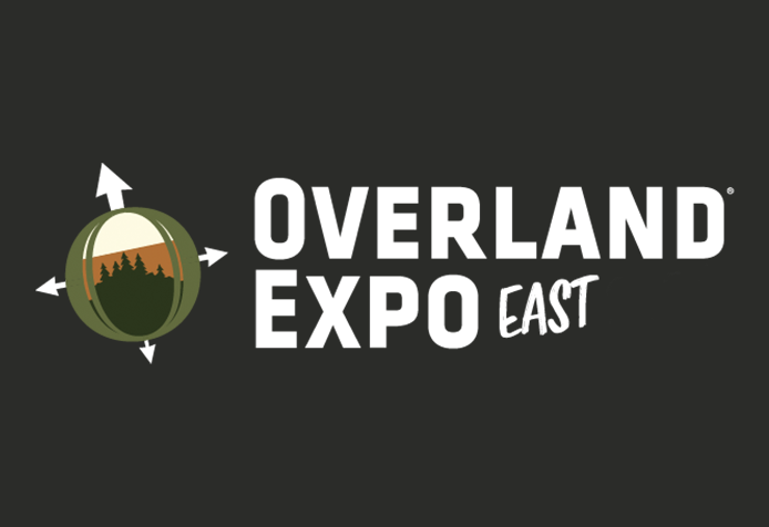 Rugged Luxury Motors at Logo for Overland Expo East with a globe and mountain landscape surrounded by compass arrows.