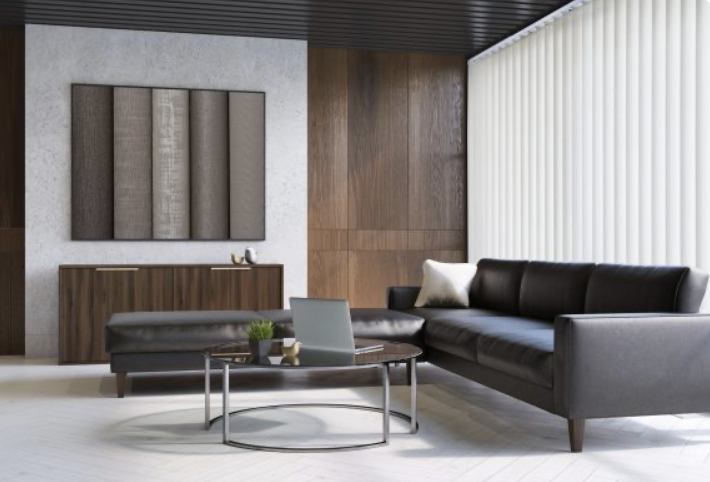 Modern living room with black leather sofa, glass coffee table, wooden wall panels, and abstract artwork, with natural light coming through vertical blinds.