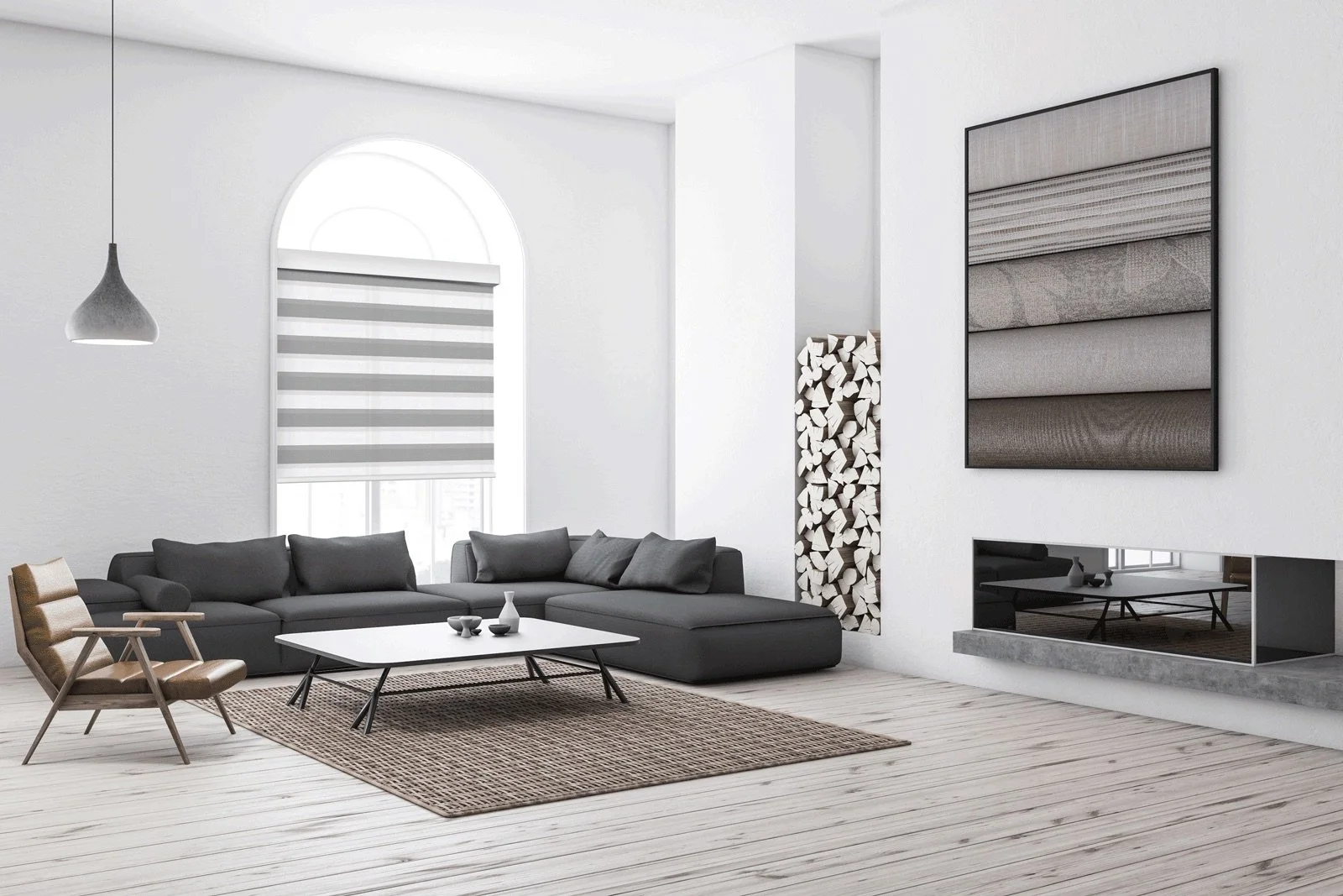 Modern living room with white walls, large arched window with striped blinds, a gray sectional sofa, a wooden armchair, a white coffee table, a fireplace with a modern design, a wall art piece with fabric swatches, and a wall neatly stacked with firewood. Light wood flooring and a woven rug complete the room's minimalist aesthetic.