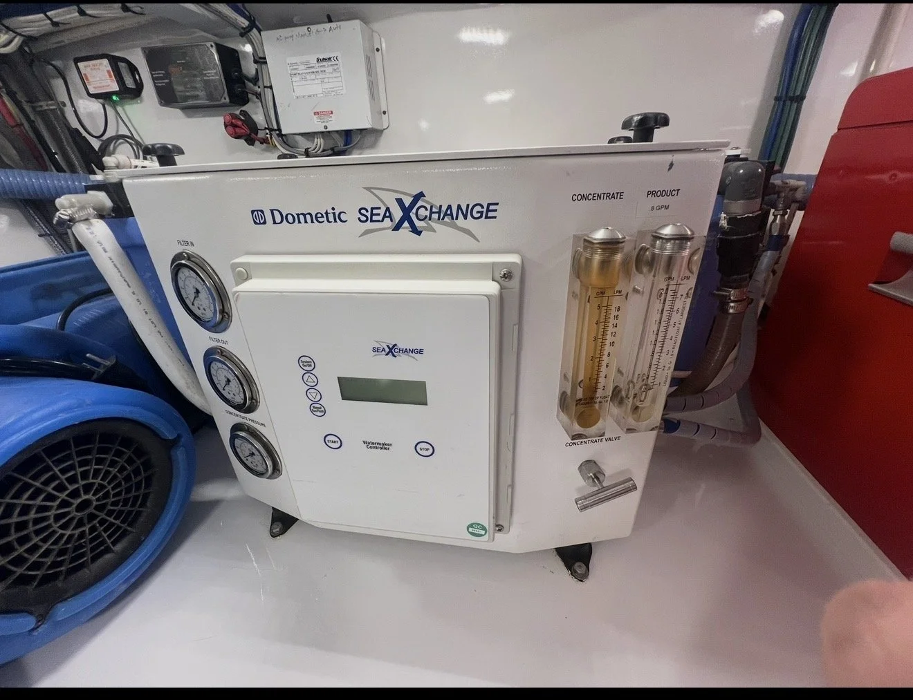 A Dometic SeaXchange watermaker with gauges, digital display, and flow meters.