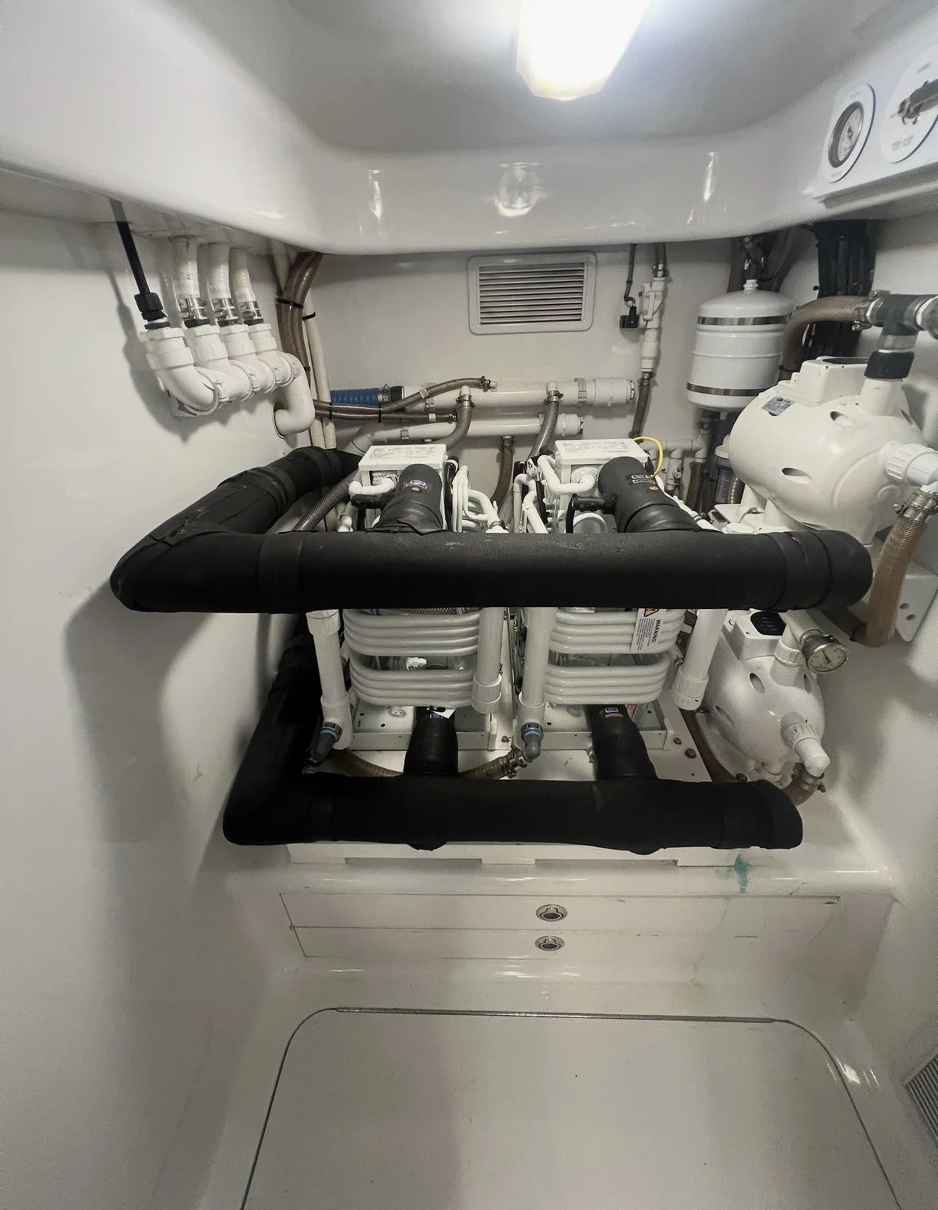 Underwater equipment room with pipes, valves, and a filtration system.