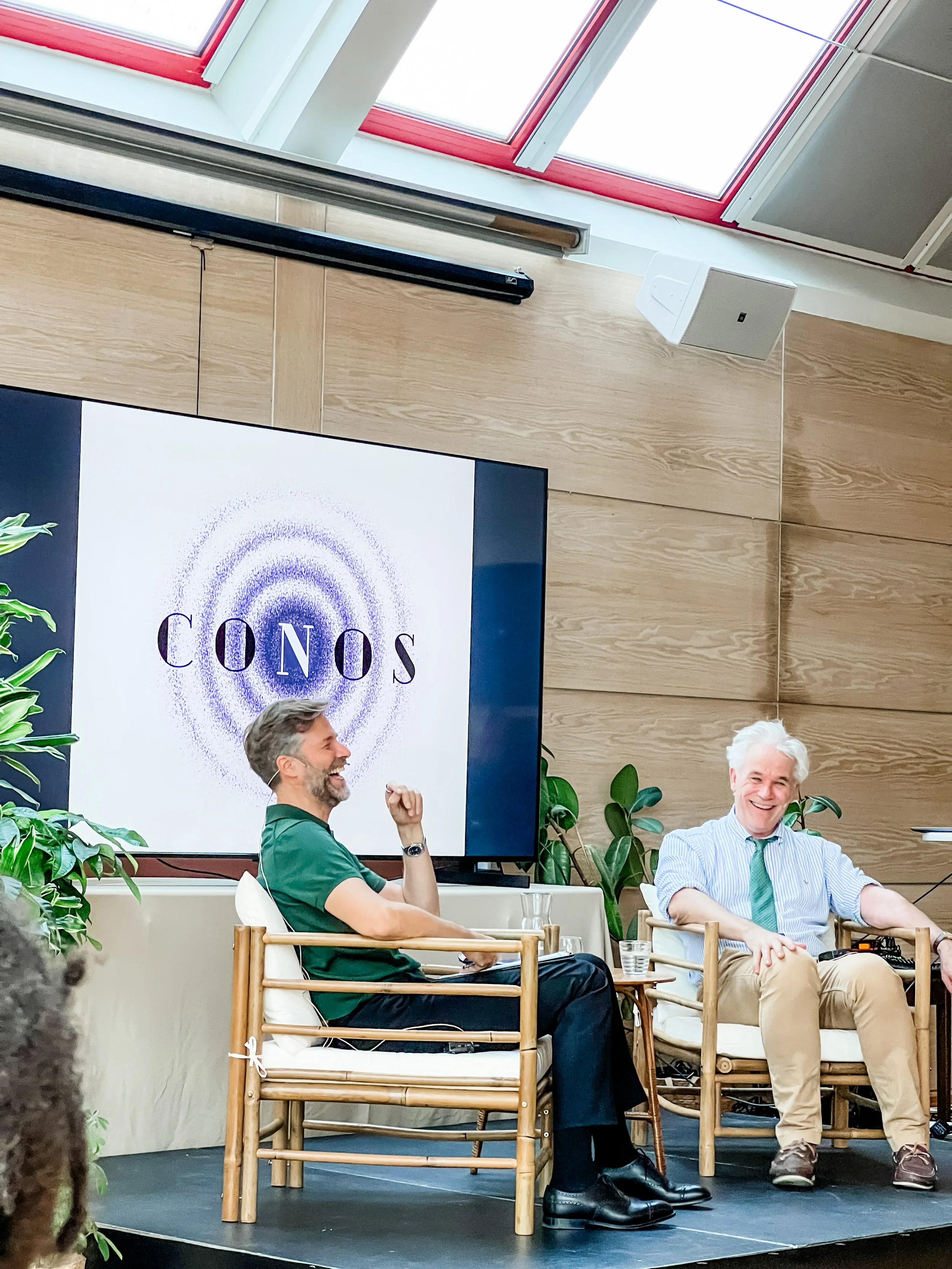 Mark Solms and Viggo Johansen laughing together during a panel discussion at CONOS for The Oslo Conversations.