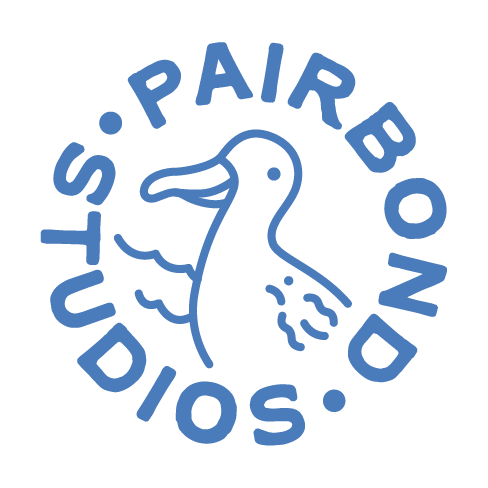Logo with an albatross outline and the words 'PAIRBOND STUDIOS' circling around it in blue text
