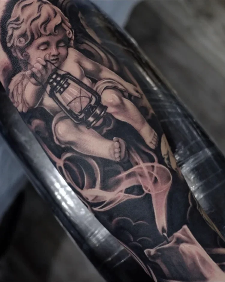 Tattoo of baby angel holding a lantern with smoke and cloud details.
