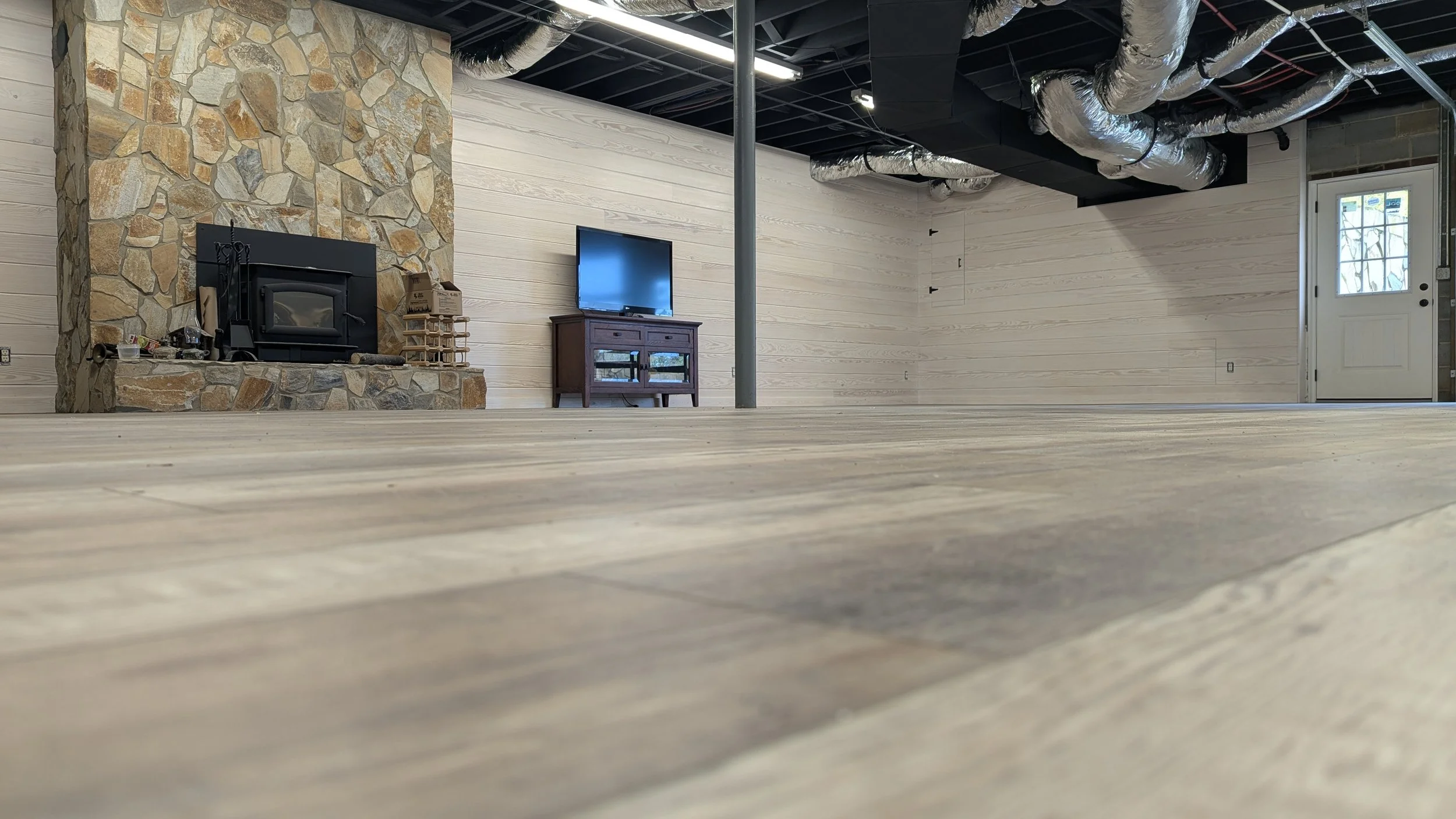 Basement conversion, Luxury Vinyl Planks, 8" Tongue and Groove Pine Board Walls, Stained.