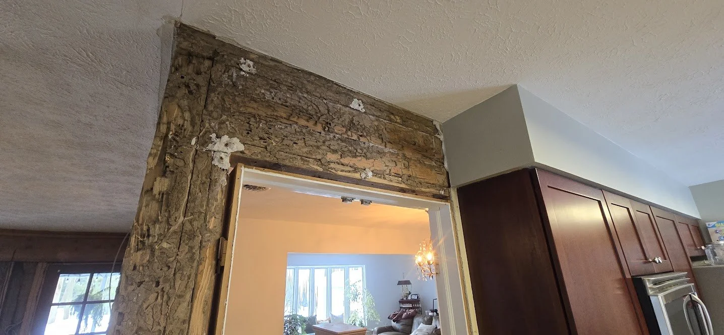deteriorated_header_above_doorway.jpg
