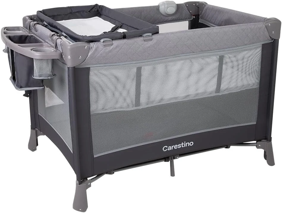 A lightweight, portable baby crib with mesh sides, gray fabric, and a nearby attached organizer with cups and small compartments.