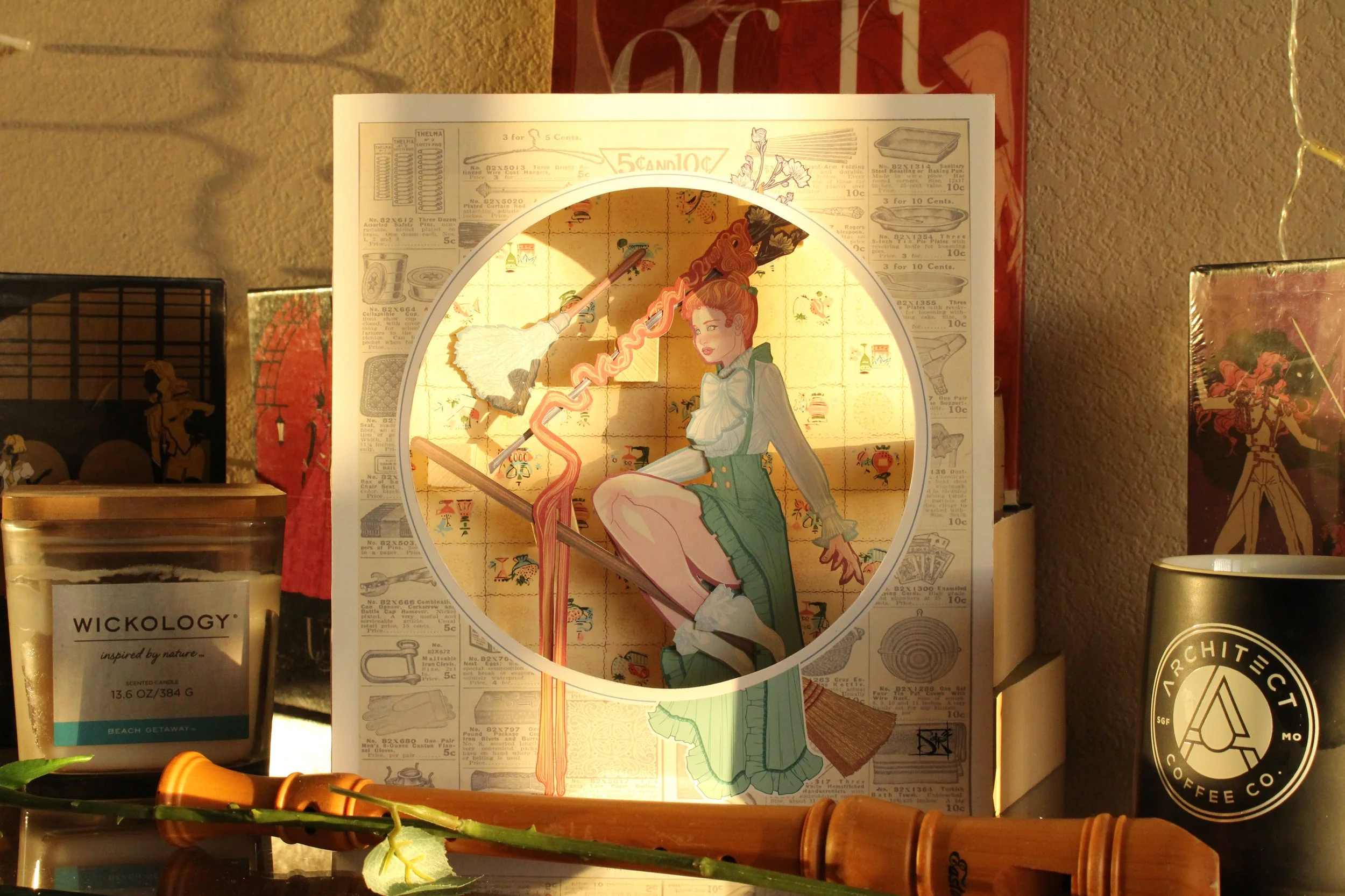 Decorative paper lantern with anime-style illustration of a woman, surrounded by vintage advertisements and product packaging, on a wall.