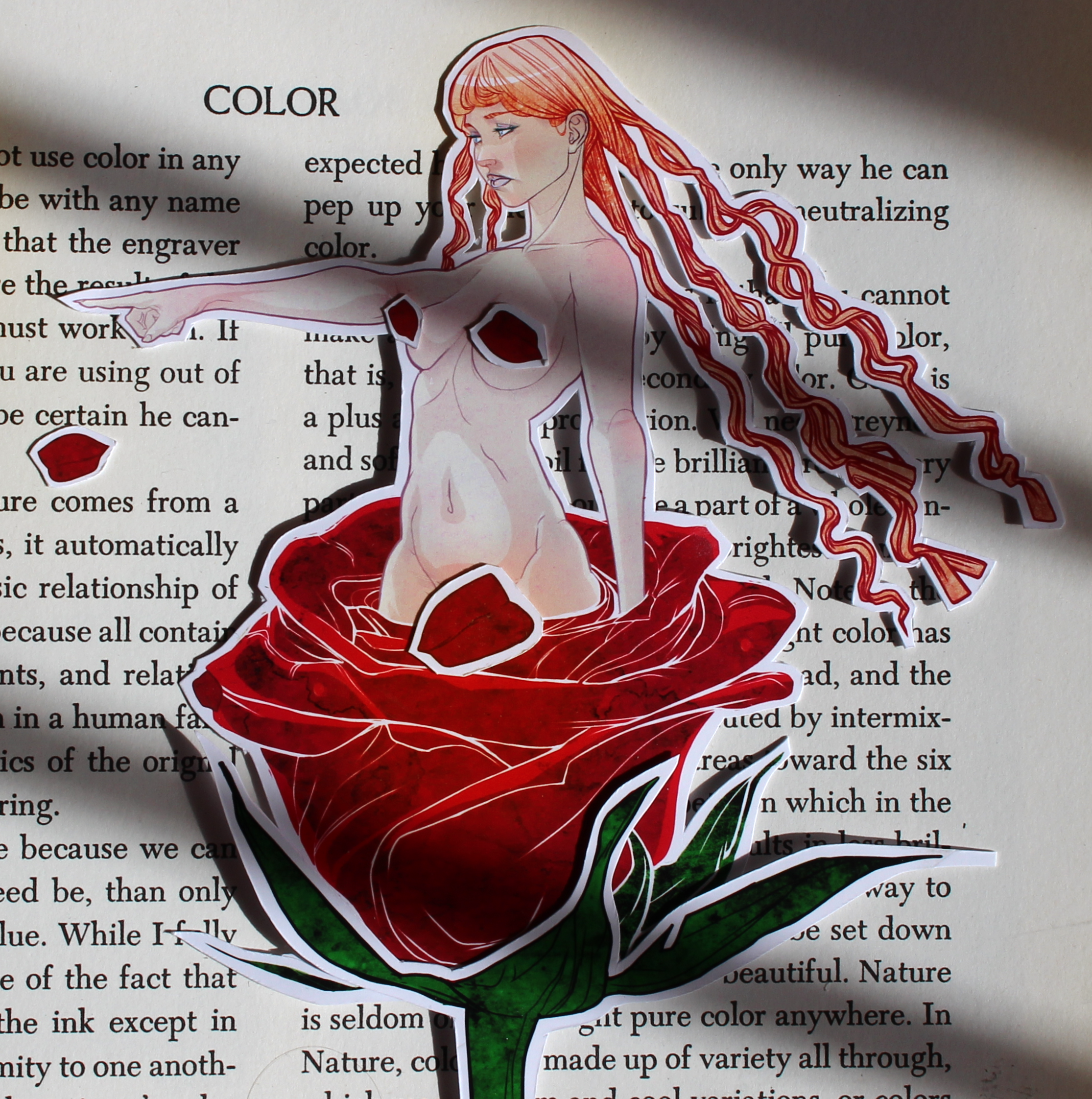Colorful sticker of a woman with long red hair, pointing with her right hand, placed over a page of text.
