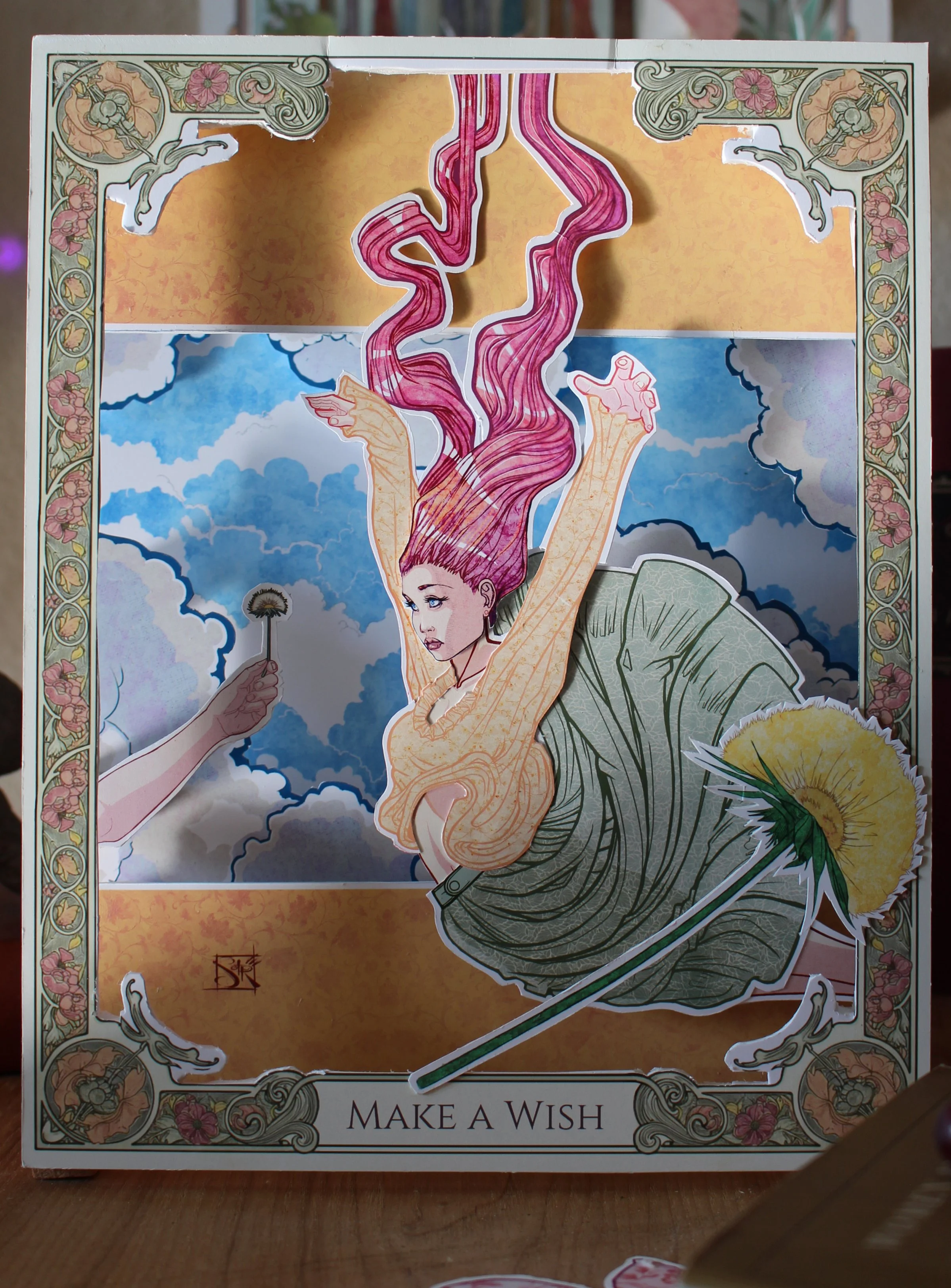 A colorful board game with a woman with pink hair, a flower, clouds, and decorative border design. The text on the game board reads 'MAKE A WISH.'