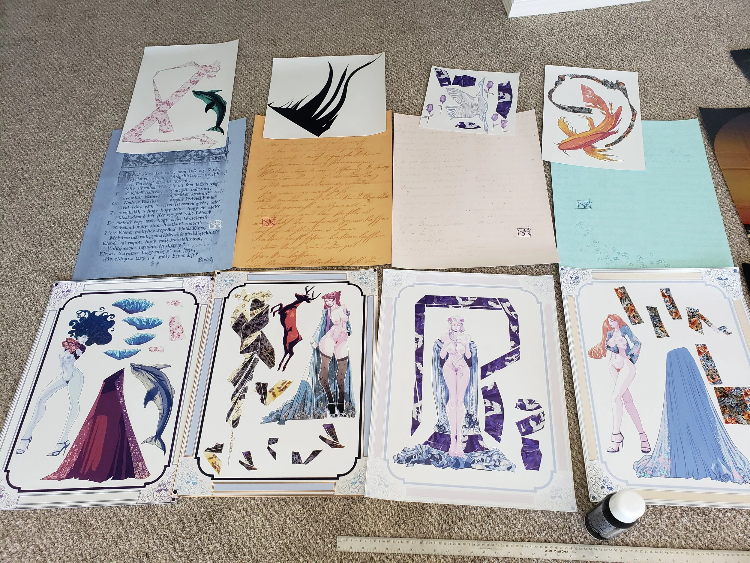 Various fantasy-themed character and scene illustrations laid out on the carpet, some on printed sheets and others on smaller pieces of paper.