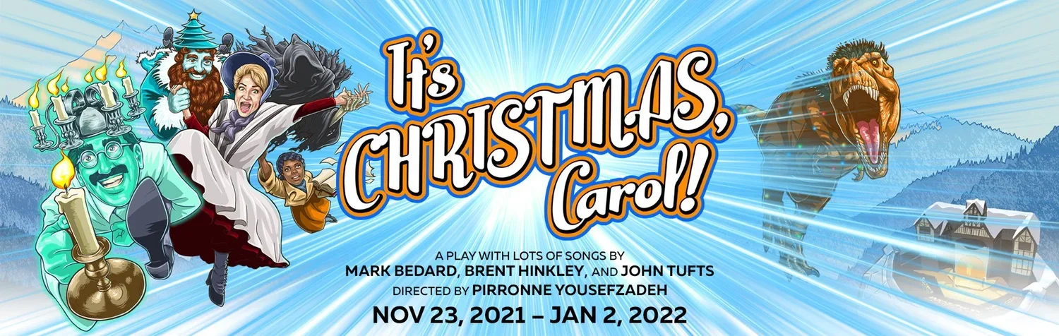 Colorful theatrical poster for the play 'It's Christmas, Carol!' featuring characters flying on a magic carpet in front of a blue radiant background with a T-Rex dinosaur on the right and a snowy mountain village in the distance. The poster includes details of the production dates from November 23, 2021, to January 2, 2022.