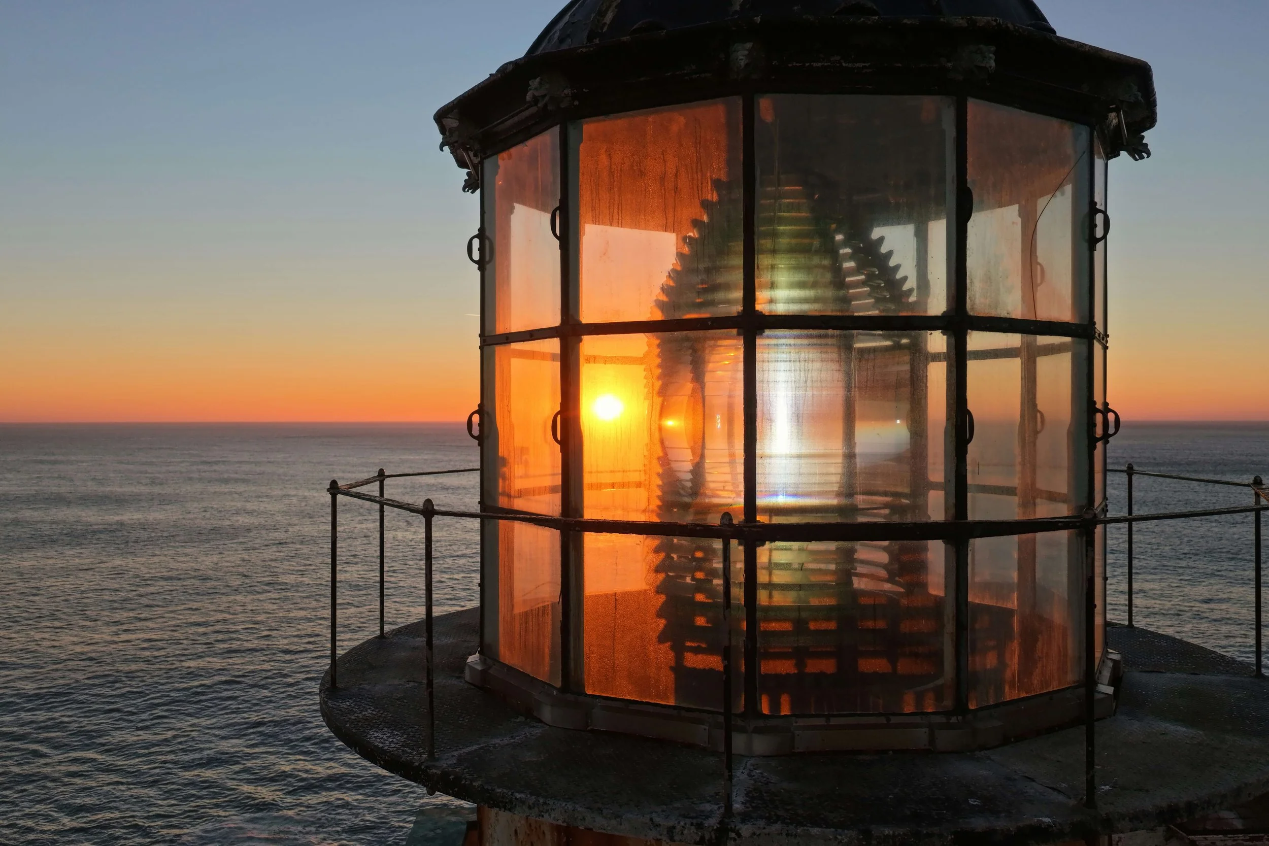 Top of a lighthouse overlooking the ocean at sunrise