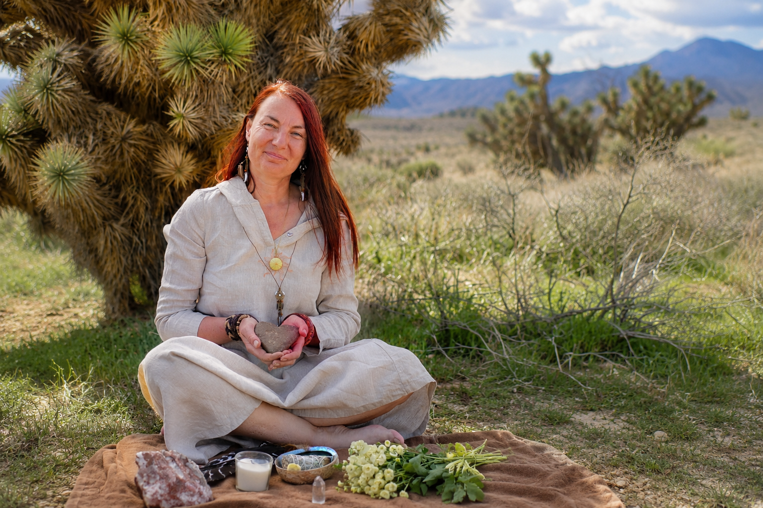Intuitive guide Silviya Doneva smiling beside a sacred altar in nature, offering intuitive readings and spiritual guidance