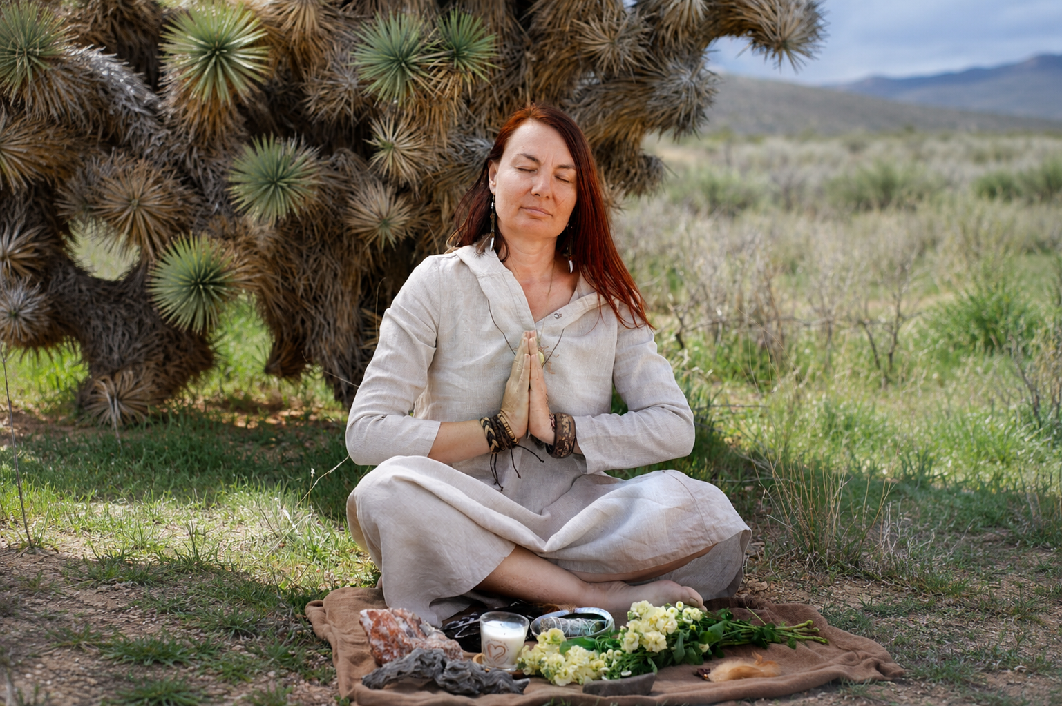 Silviya of The Butterfly Alchemy in prayer before a healing altar in nature, offering private energy healing, shamanic healing, and intuitive guidance sessions.