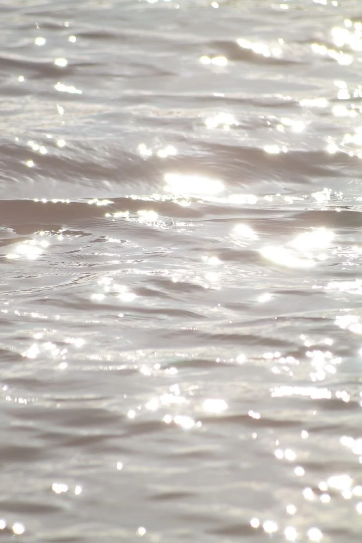 Close-up of sunlight reflecting on gentle water ripples.