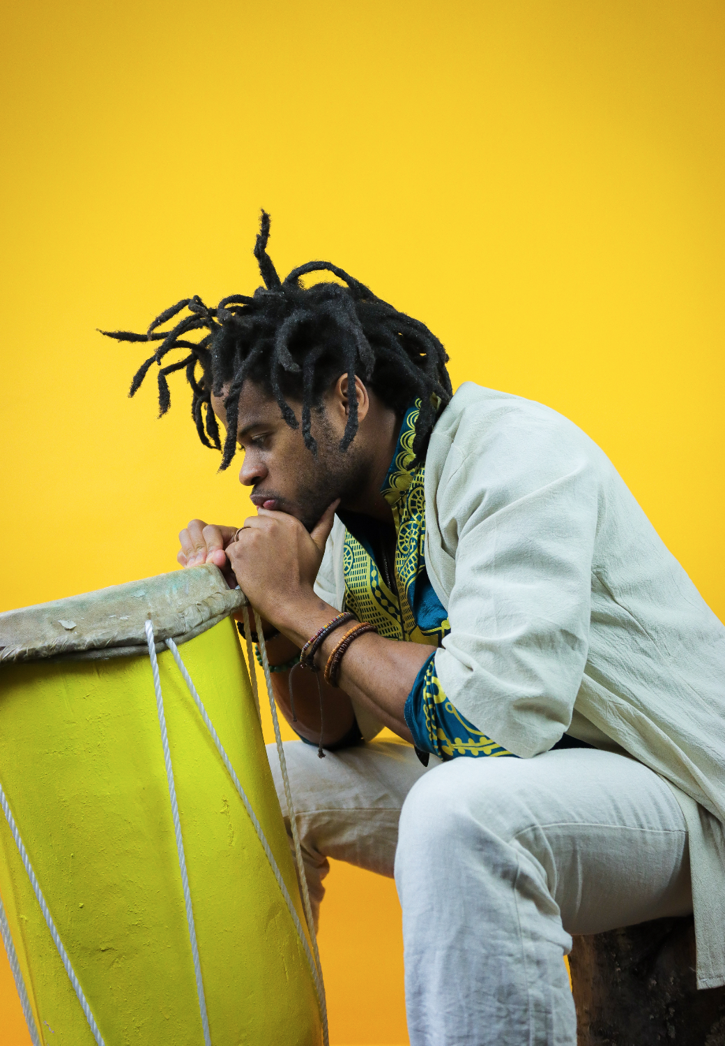 Haitain artist looking at a Haitian Mitan or petwo drum.