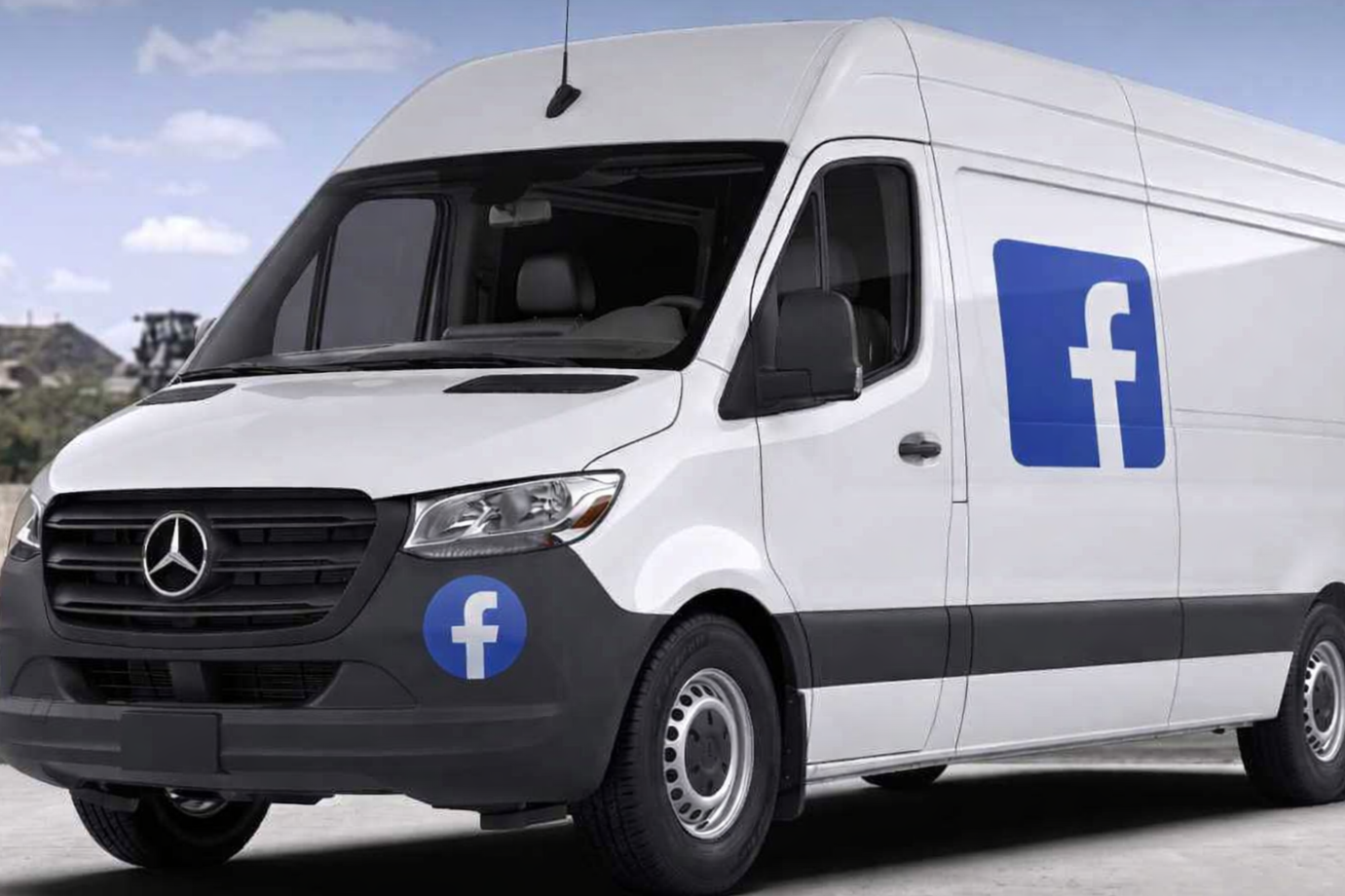 White Facebook-themed delivery van with Facebook logos on the front and side, parked outdoors under a partly cloudy sky.