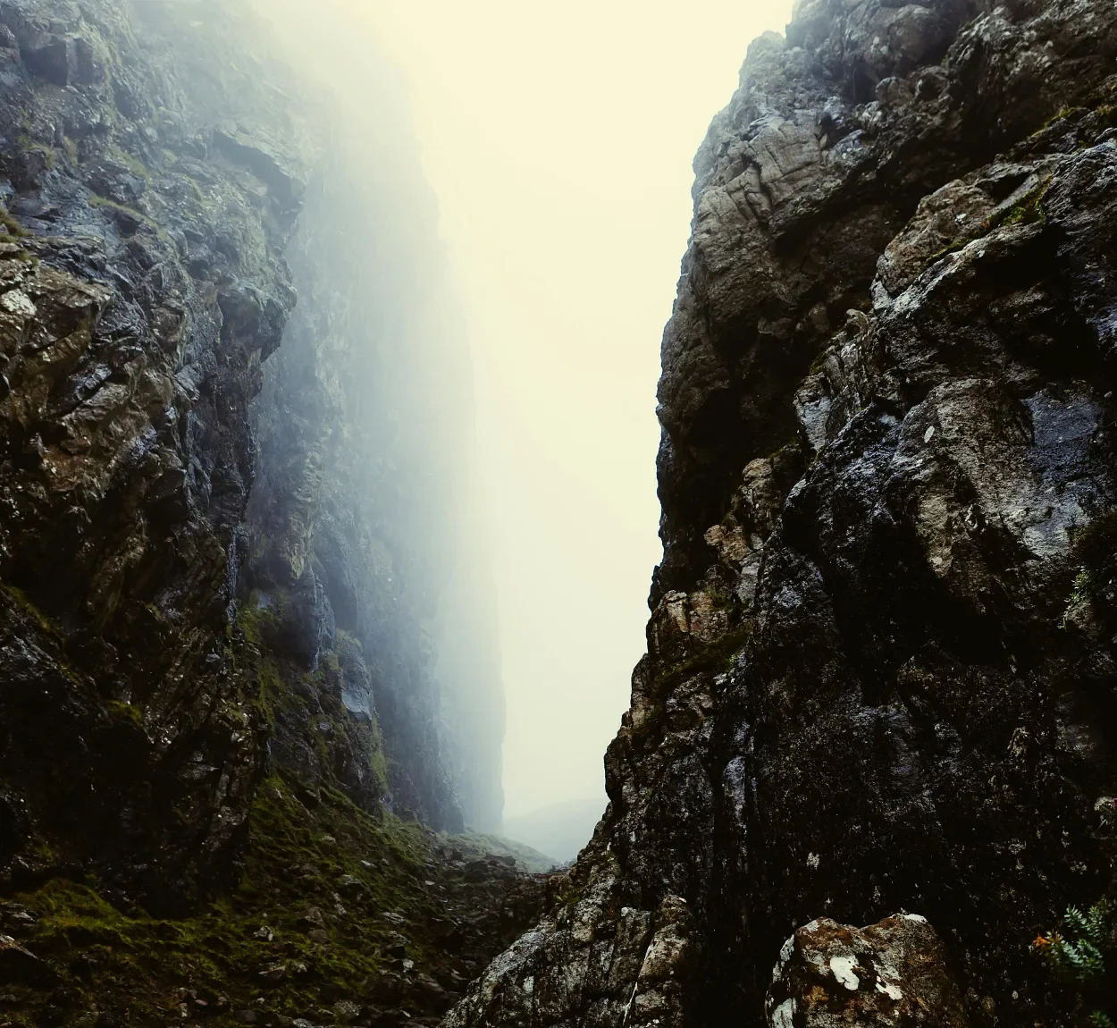 Rock valley opening into misty landscape
