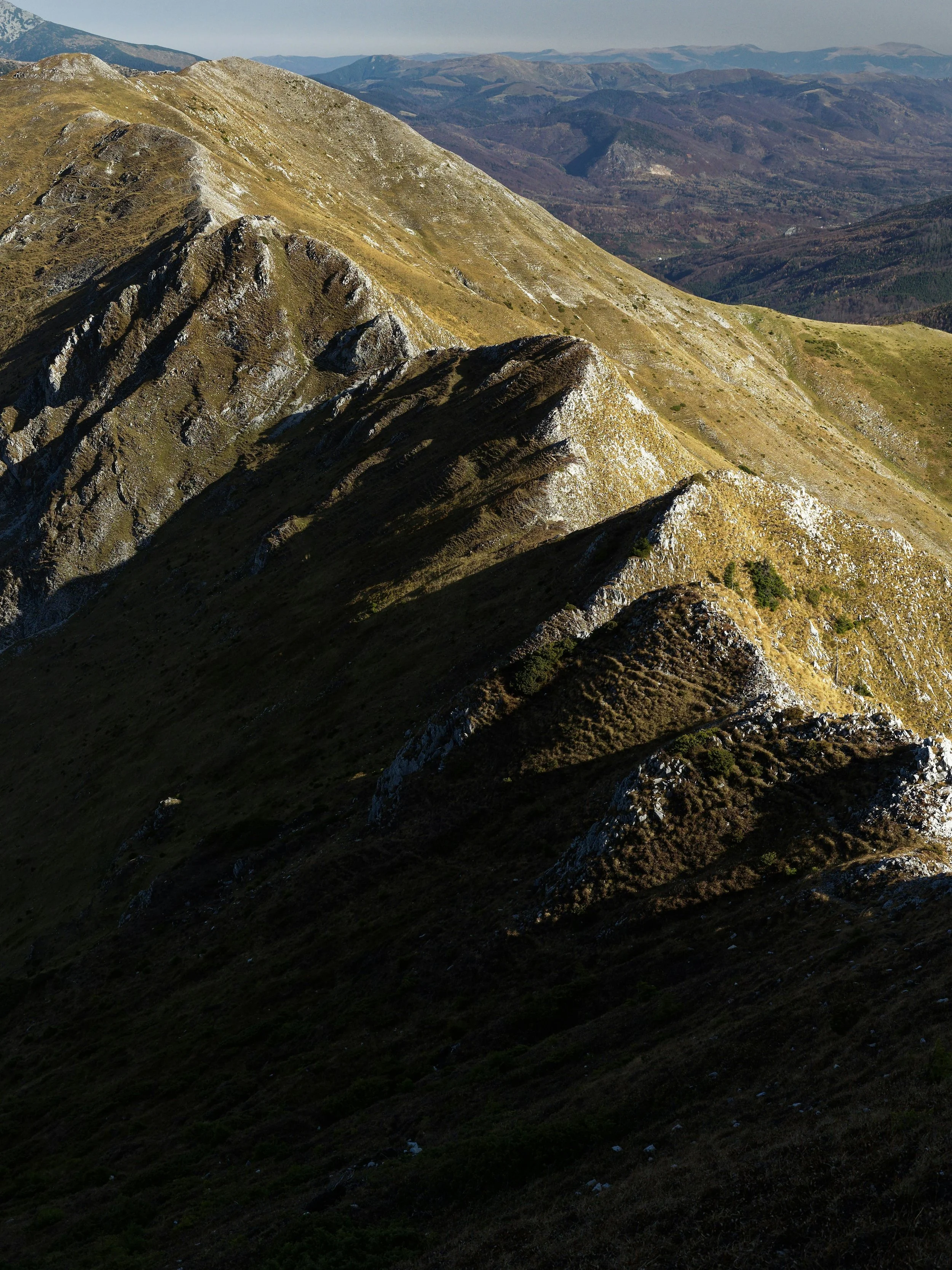 Aerial view of a mountain range with contrasting light and shadow