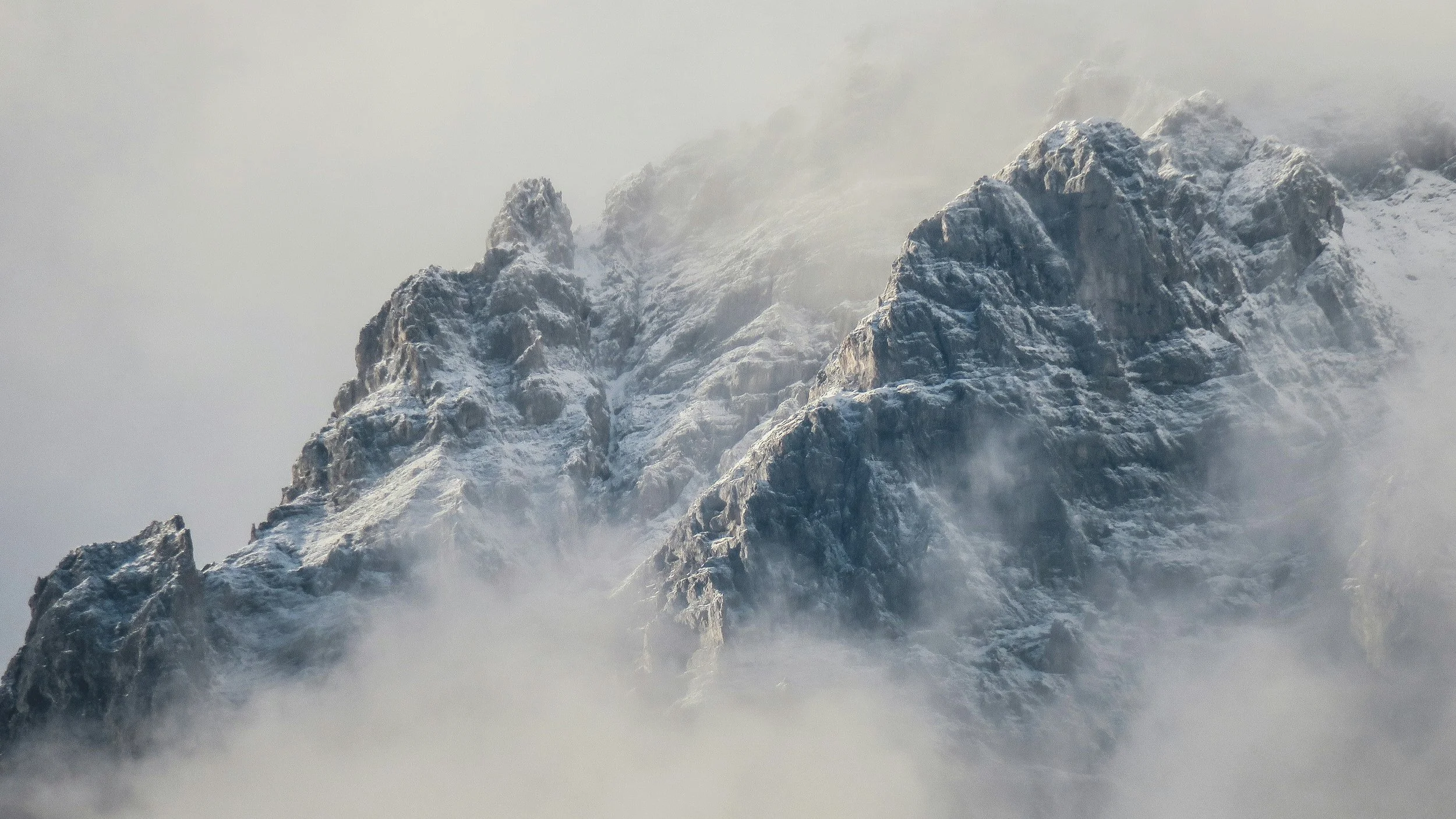 Snow‑covered mountain cliffs