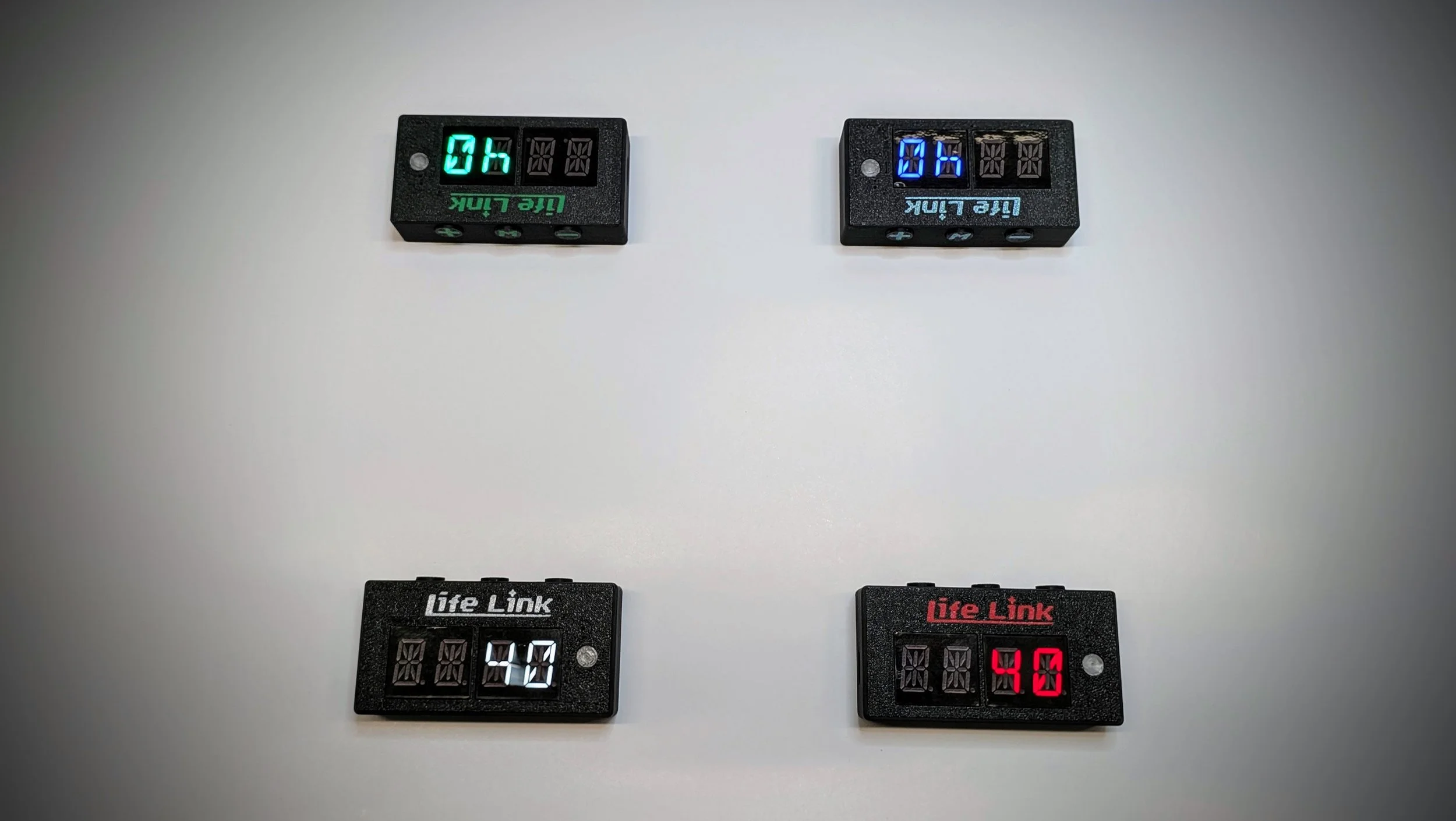 Two digital chess clocks on a white surface, one with a green display showing 0 hours and 40 seconds, labeled"VIE Link," and the other with a blue display showing 0 hours and 40 seconds, also labeled"VIE Link."