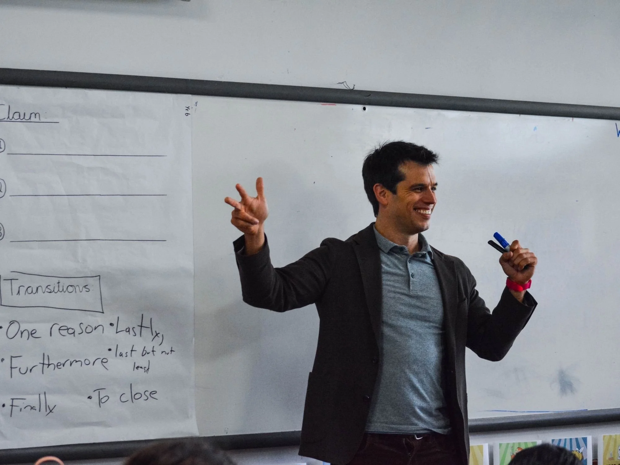 Gerrit Jones-Rooy leads a classroom lesson beside a whiteboard.