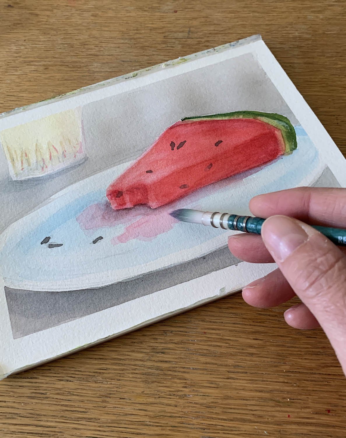 Watercolor painting of a slice of watermelon on a plate