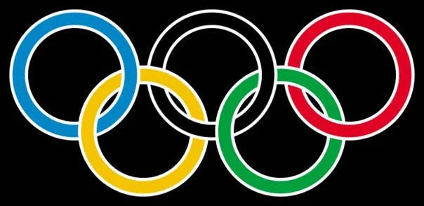 Olympic rings in blue, black, red, yellow, and green on a black background.
