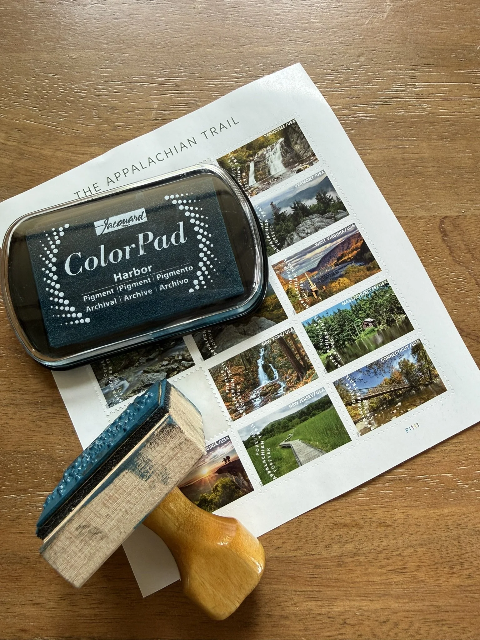 Postage sheet with Appalachian trail scenery stamps and a colored inkpad and wooded address stamp.