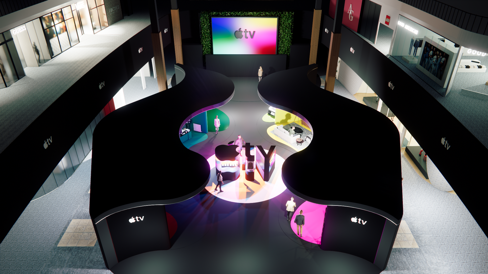An interior view of a multi-level retail space showcasing Apple TV branding, with a central curved area displaying colorful exhibits and a large screen at the back. The space features sleek black curved structures with the Apple TV logo, surrounding illuminated display sections, and shoppers walking around.