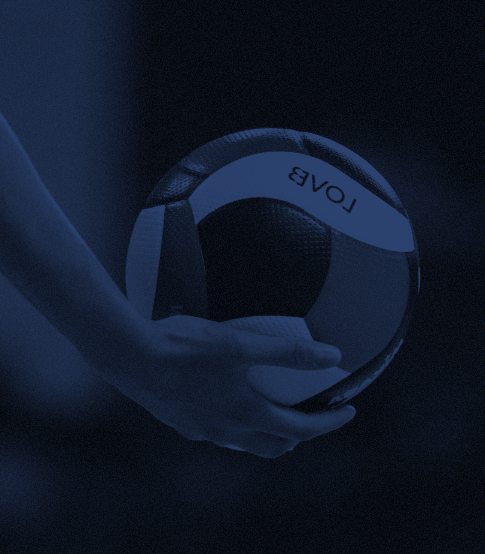 A hand holding a volleyball labeled 'LOVAB' against a dark background.