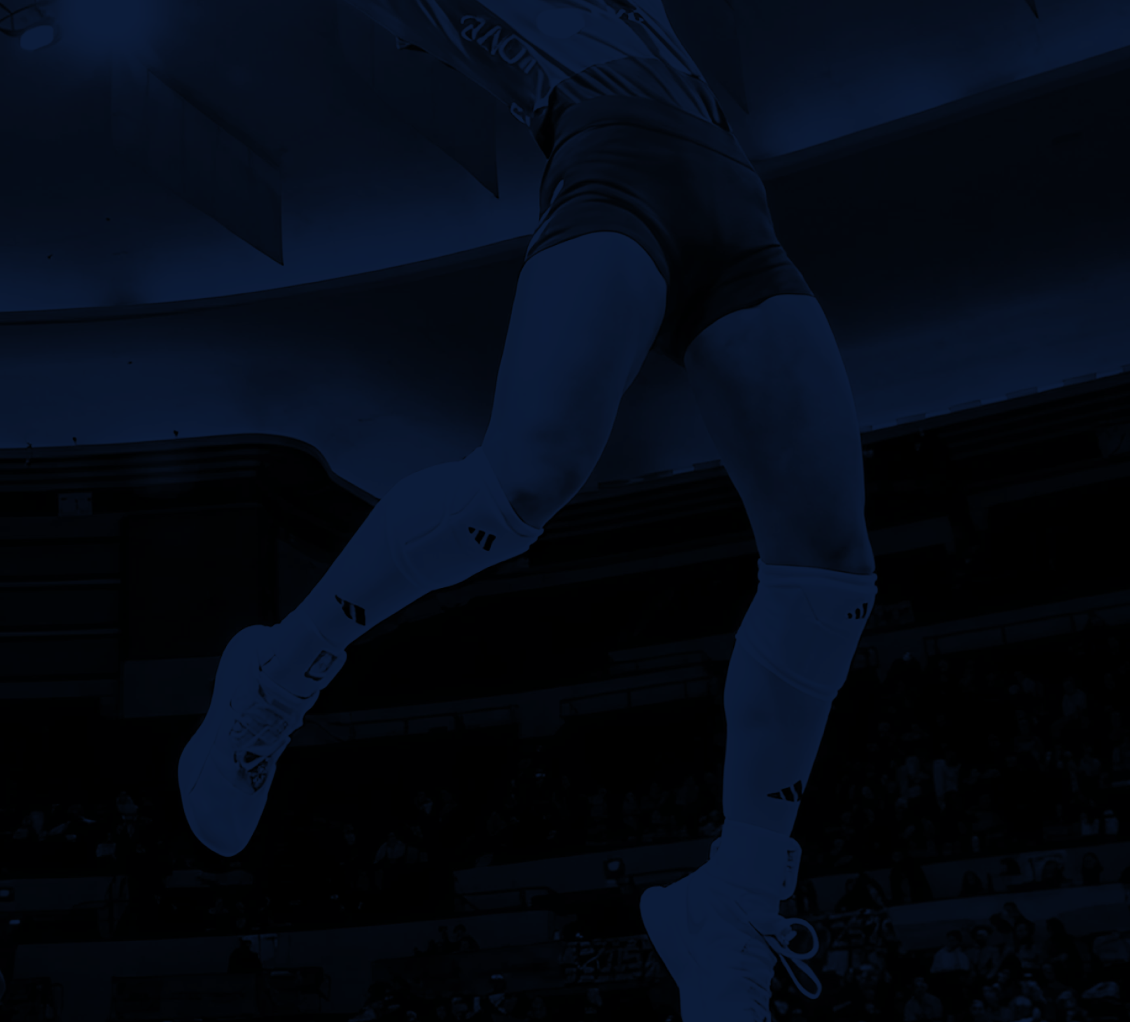 Artist's impression of a volleyball player jumping, shown from the waist down, with a volleyball in hand, in an indoor stadium.