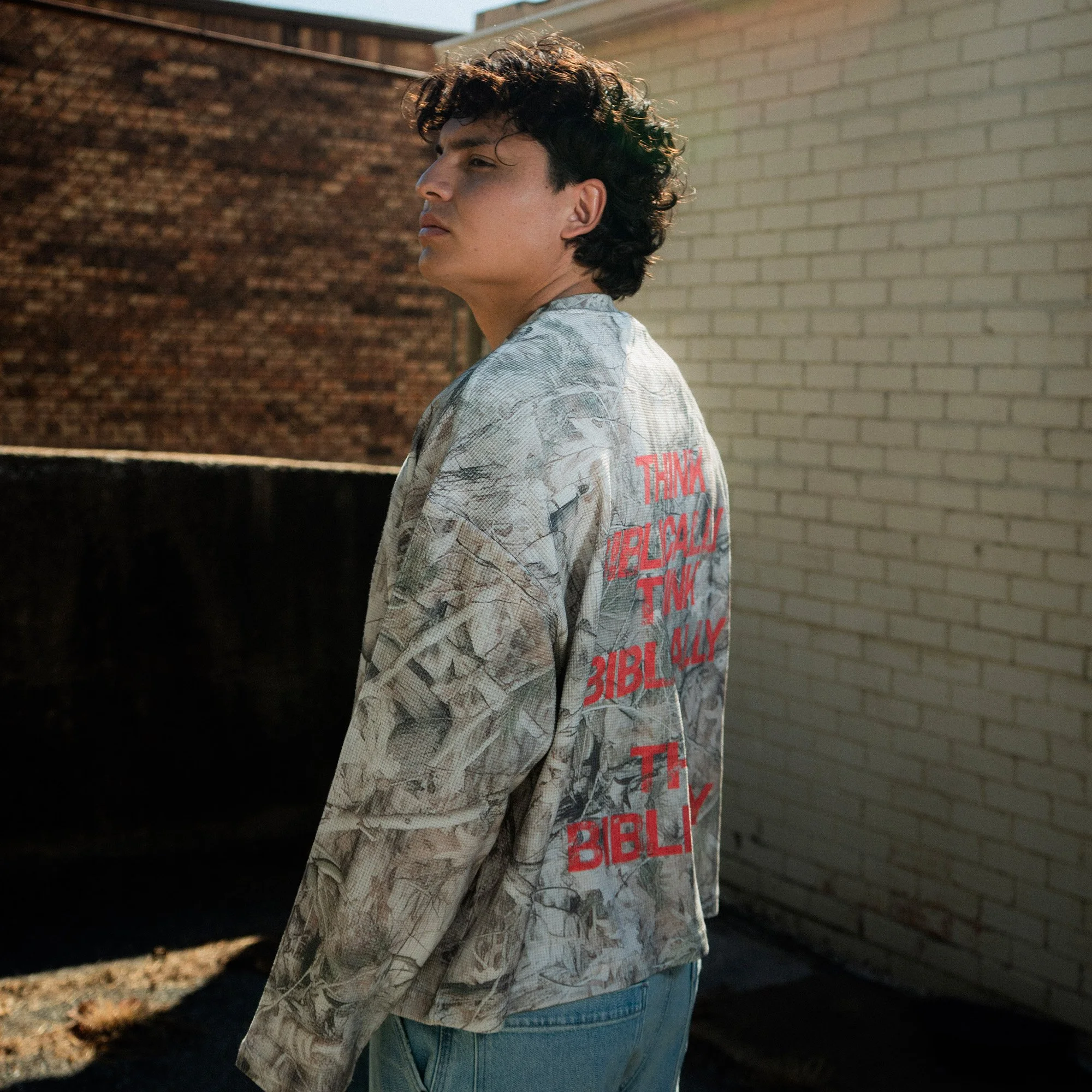 Think Biblically Camo Long Sleeve back three-quarter view, worn by model