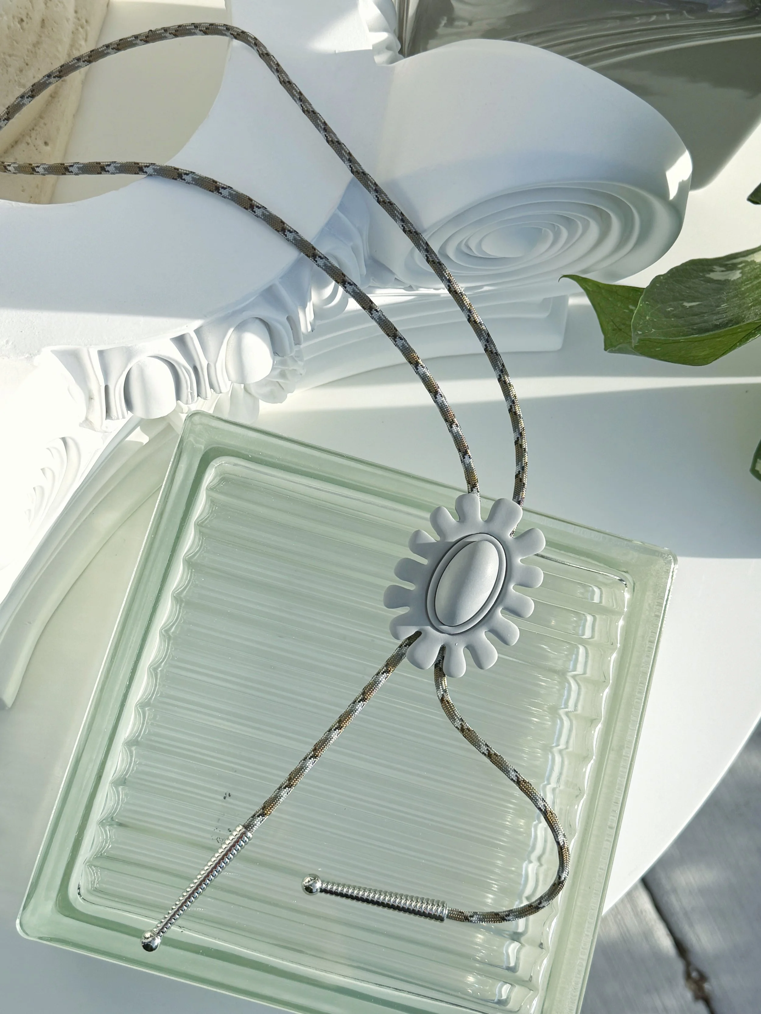 The Brio Bolo Tie in Grey Polymer Clay  with Grey, Light Tan, and White Paracord