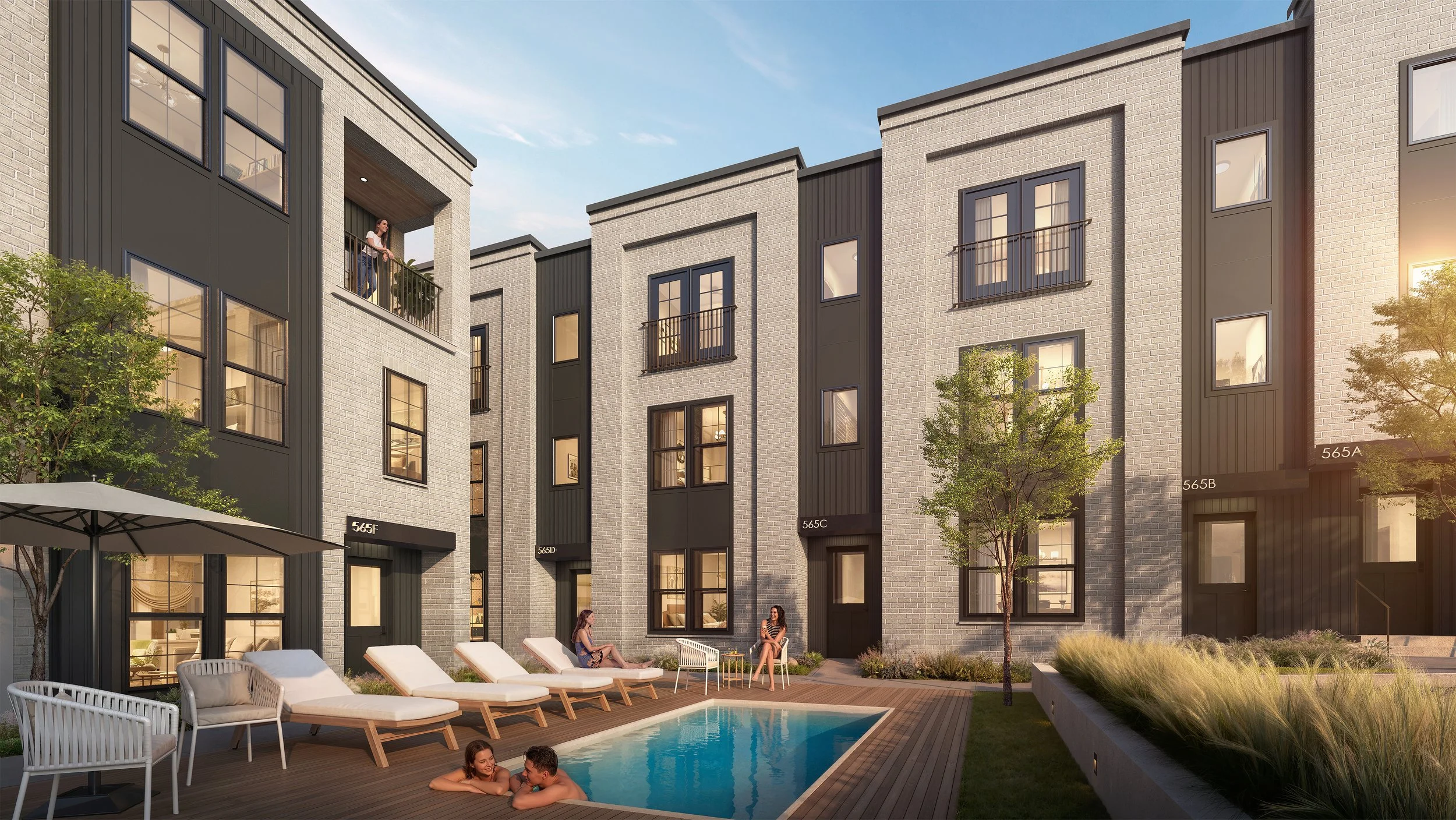 Modern apartment complex courtyard with a swimming pool, lounge chairs, and people relaxing and socializing in the late afternoon sunlight.