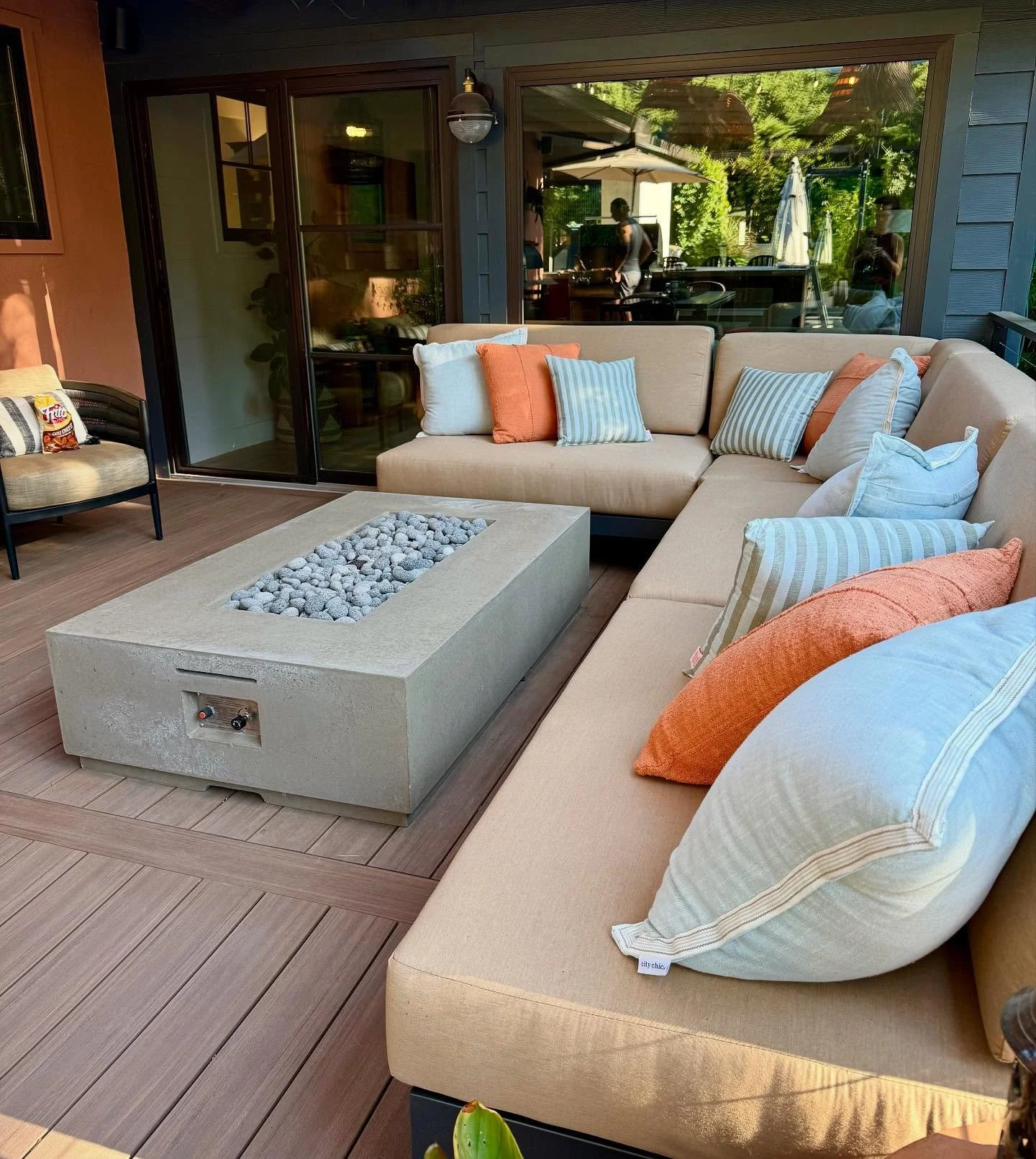 I think this photo of my new outdoor living space is some of my most professional photographic work ever. Somehow I managed to catch my own reflection, my husband&rsquo;s reflection, and a serendipitously placed bag of Fritos chili cheese corn chips 