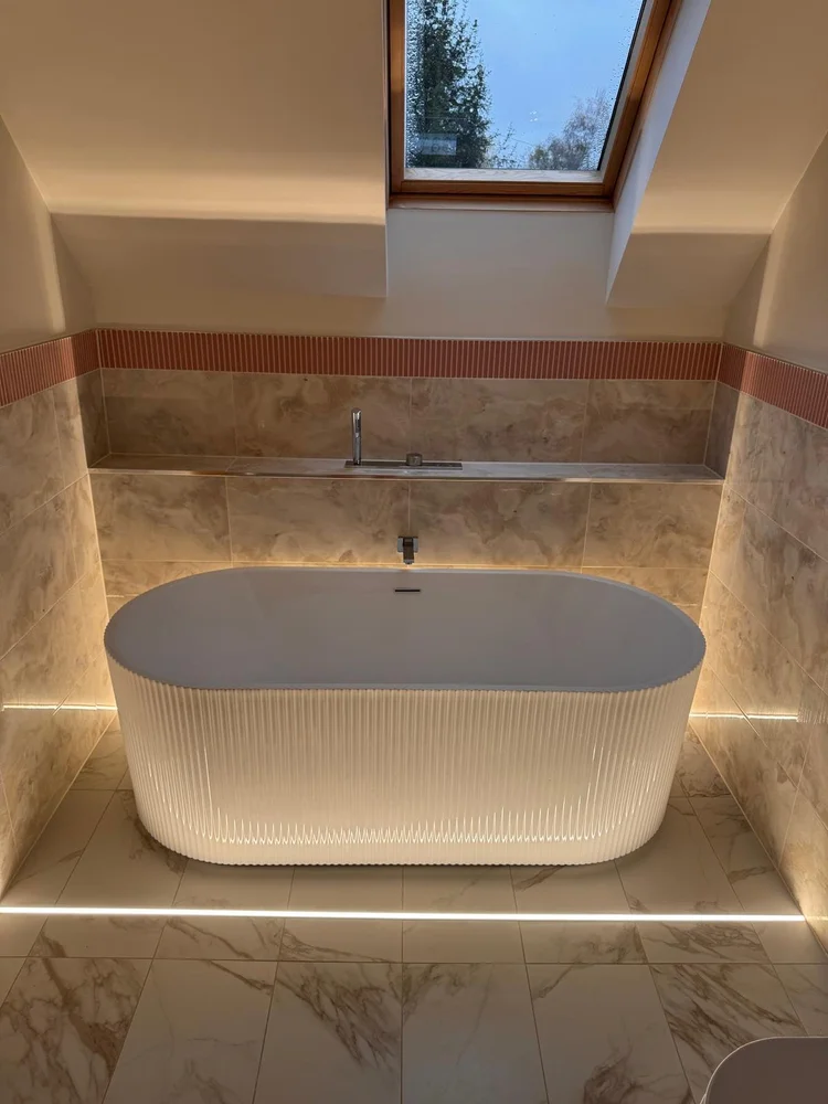 Fluted freestanding bath with LED base lighting and Velux skylight — luxury bathroom Nottingham