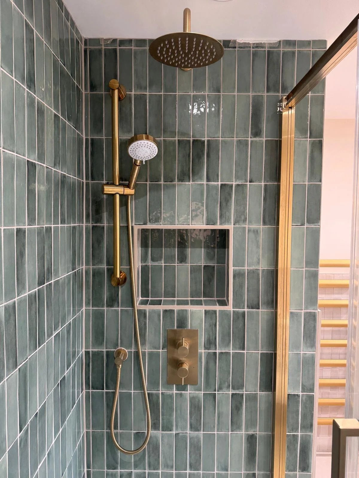 Green tiled shower with gold fittings and built-in niche - bathroom installation Nottingham - M.R. Pro Bathrooms