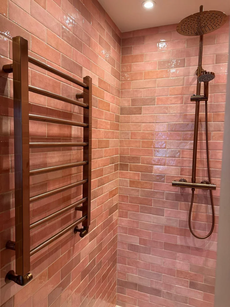 Pink zellige tiled bathroom with antique bronze shower and matching towel rail — bathroom installation Nottingham