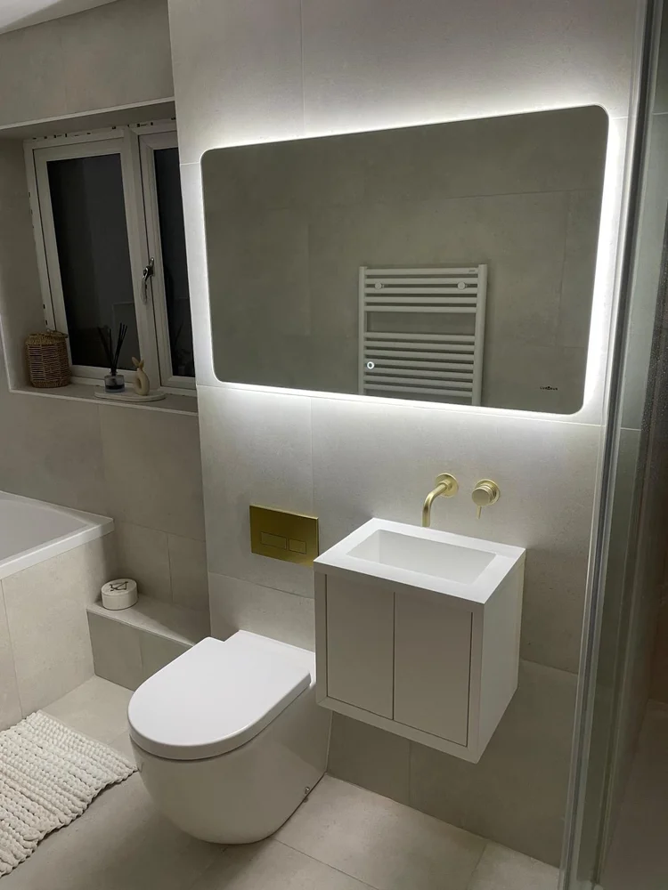Modern bathroom with large LED backlit mirror and concrete-effect tiles — bathroom installation Nottingham